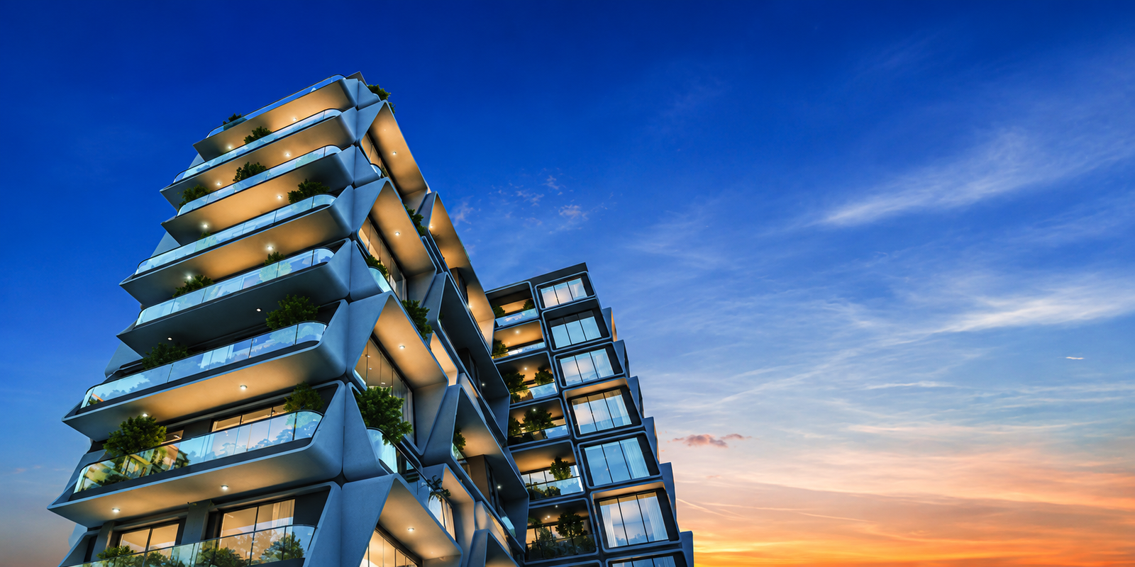 Emami Aamod luxury residential towers rising at dusk above the waterfront in New Alipore, Kolkata